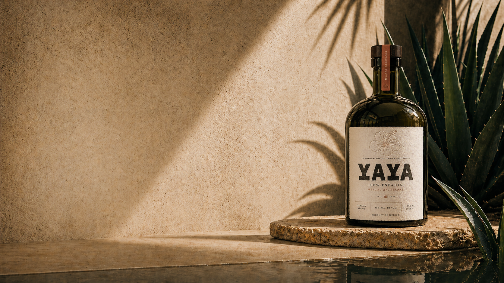 YAYA Mezcal bottle on travertine with agave and palm shadows